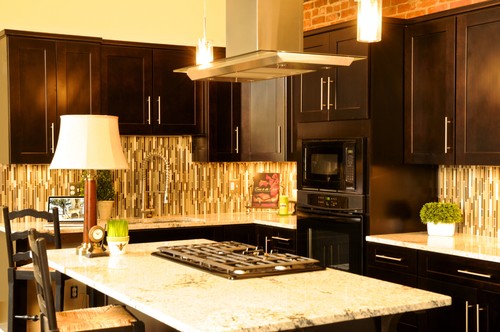 Bianco Romano Countertops and Bianco Romano Island Top, Dark Chocolate Finish Maple Cabinets , Vertical Glass Tile and Stainless Steel Vent Hood